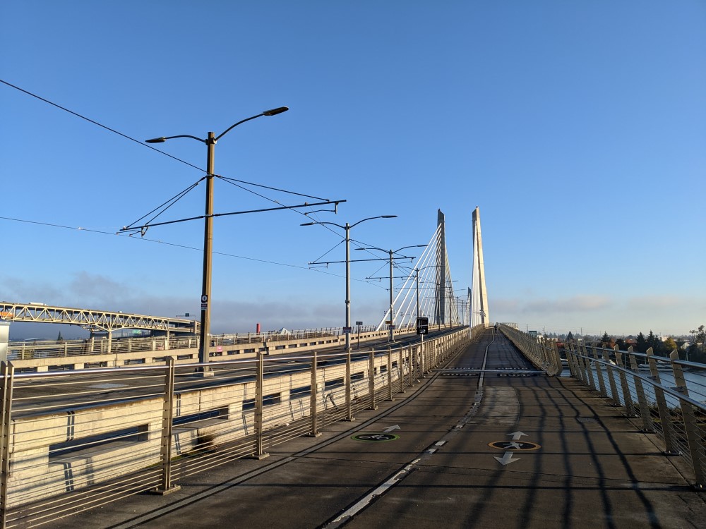 A cable stayed bridg3e with a large bike path and a transit lane in the middle, with a photo taken down it as viewed from the bike path.